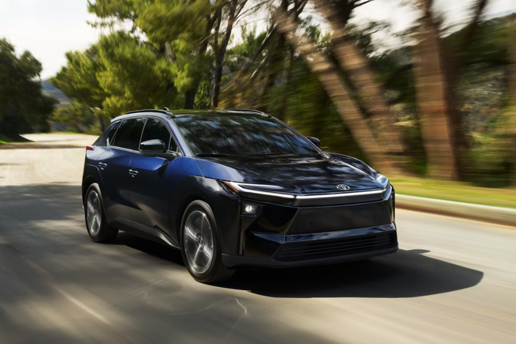 Toyota bZ electric SUV driving on a tree-lined road near Vallejo